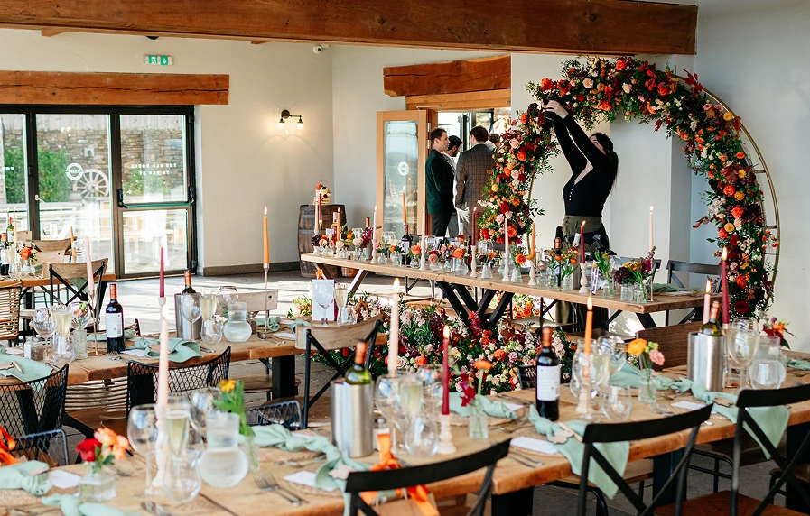 Becca Lloyd photographing a table with flowers